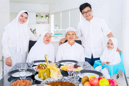 Muslim family looking at camera together at home