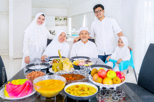 Muslim family smiling at camera together