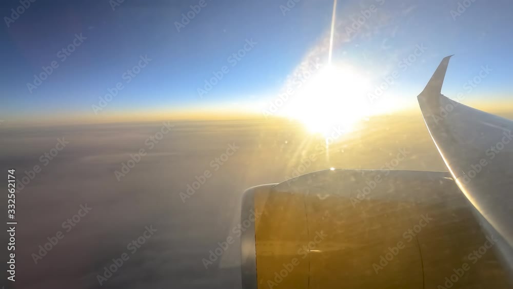 4K time lapse high attitude with a lot of thick clouds, the view taken from aeroplane window during sunset.