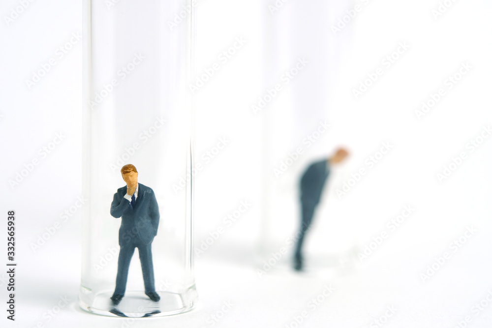 Health conceptual miniature people photography – testing specimen, a businessman on a laboratory tube Health conceptual miniature people photography – testing specimen, a businessman on a laboratory tube