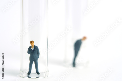 Health conceptual miniature people photography – testing specimen, a businessman on a laboratory tube