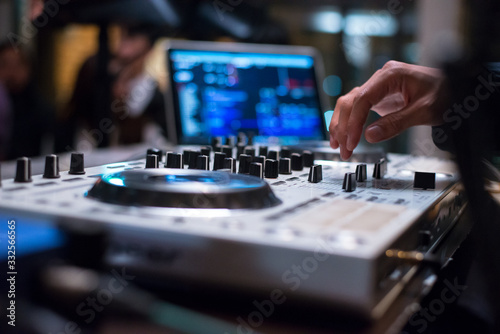 Dj mixing music track by hand on turn table