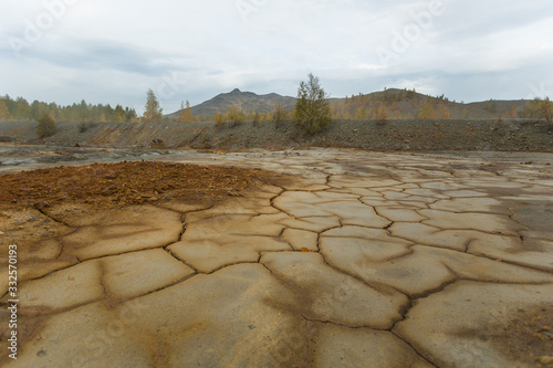 landscape with red soil polluted copper mining factory in Karabash, Russia, Chelyabinsk region photo