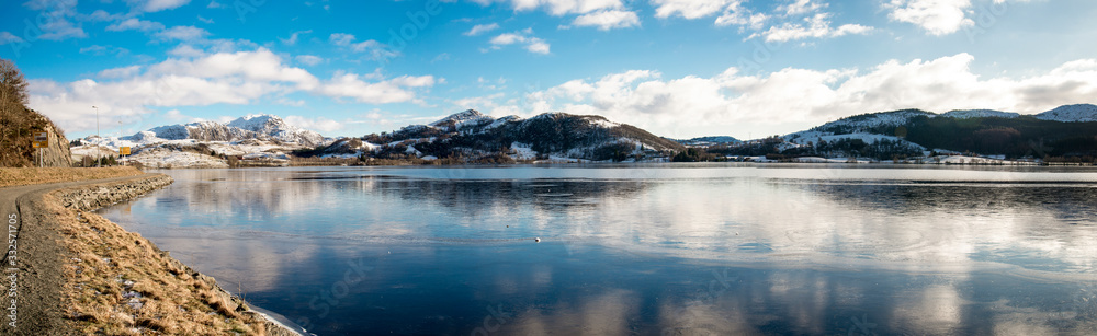 A scenic panoramic view of Edlandsvatnet lake and mountain landscape in winter season near Algard town, Gjesdal commune, Norway, February 2018