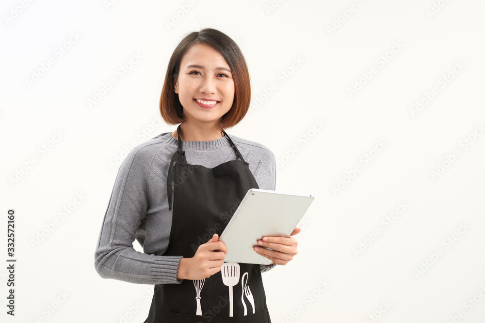 Beautiful female owner using digital tablet on white Beautiful female owner using digital tablet on white