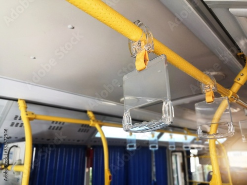 Clear Plastic bus grab handle.Clear Plastic hanging handhold for standing passengers in a modern bus. Suburban and urban transport.