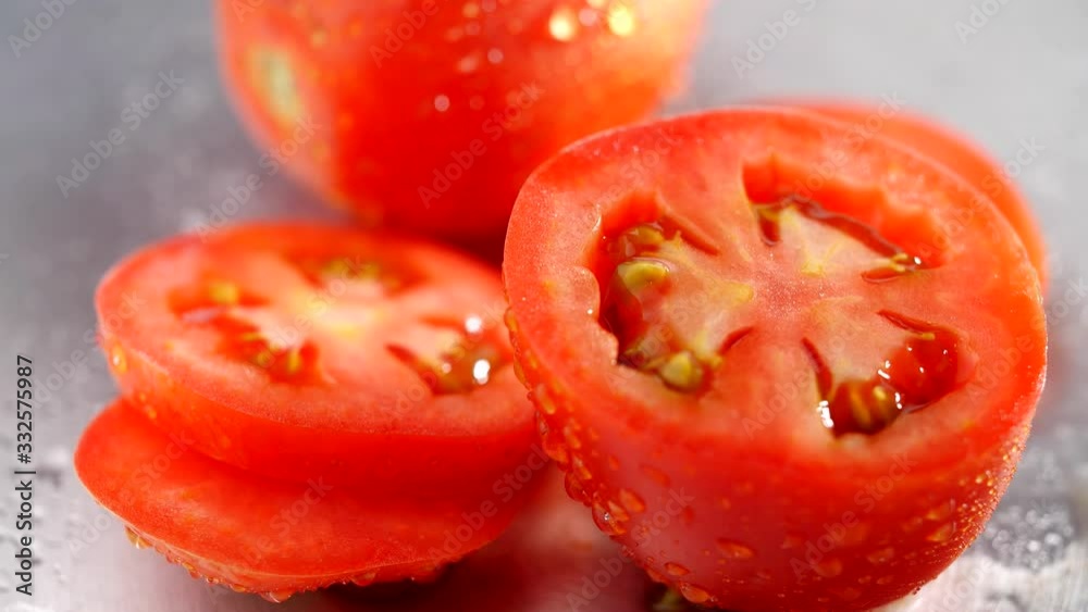 Fresh Tomato sliced with dripping water. Organic tomato rotating in 4K resolution Fresh Tomato sliced with dripping water. Organic tomato rotating in 4K resolution
