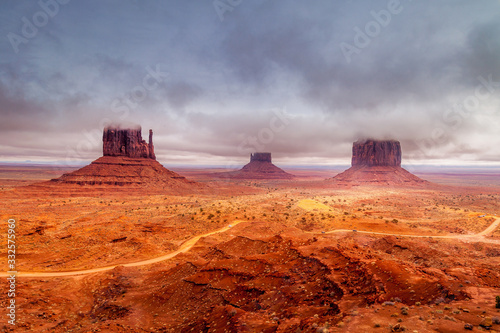 Low clouds hang over the Mittens of Monument Valley Navajo Tribal Park