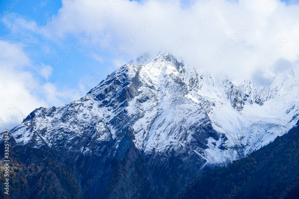 Obraz premium Cloud covered holy peaks of Kinner kailash Mountains of Himalaya seen from Kalpa Himachal Pradesh India