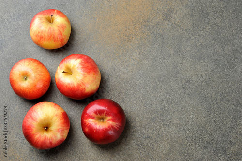 whole red ripe apples on a gray background