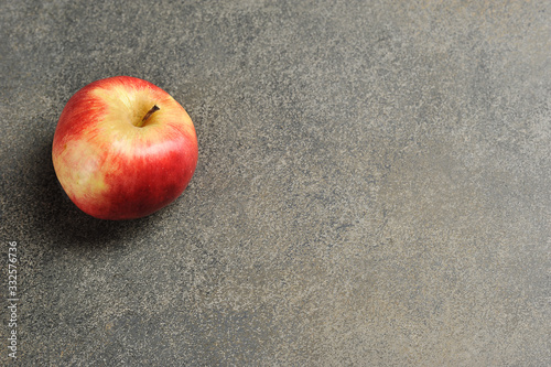 red Apple on a gray background - top view