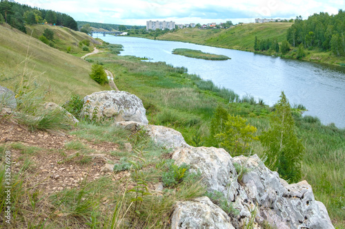 view from the bank to the river and in the middle of the river islet around the forest