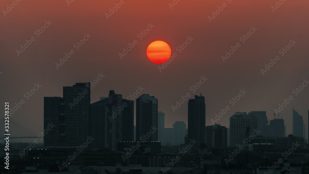 Fototapeta premium Bangkok sunset, falling sun over big city with huge buildings