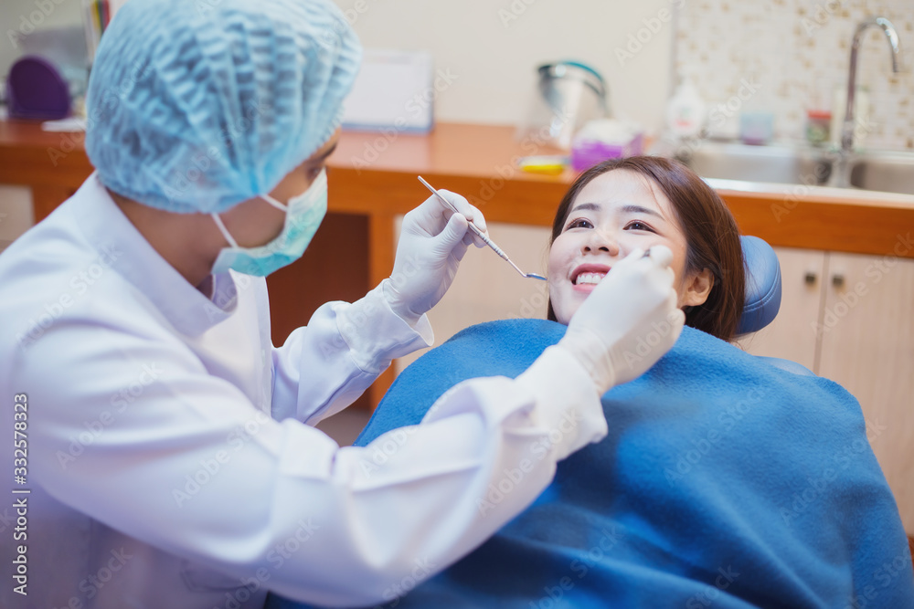 Dentists examining patients lying in chair in a dental clinic. Dentists examining patients lying in chair in a dental clinic.