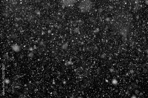 Snowfall. Falling snowflakes on black background.