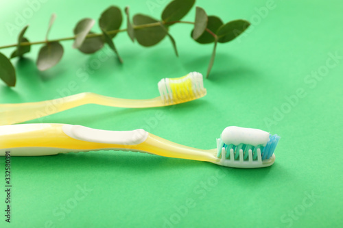 Tooth brushes with paste on color background