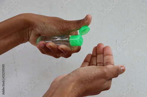 Hands using wash hand sanitizer gel dispenser for killing germs, bacteria and virus