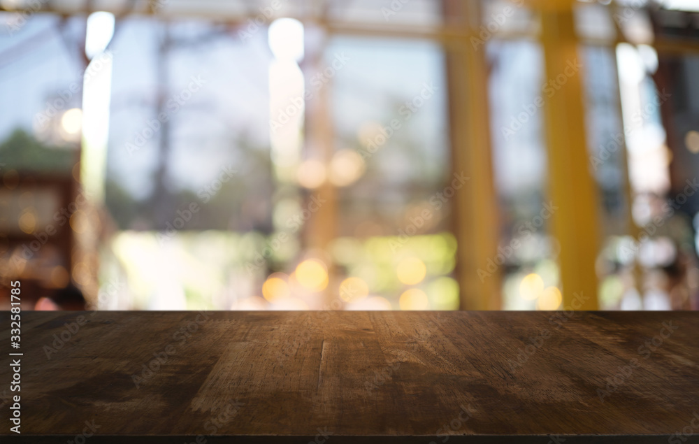 Empty dark wooden table in front of abstract blurred bokeh background of restaurant . can be used for display or montage your products.Mock up for space. Empty dark wooden table in front of abstract blurred bokeh background of restaurant . can be used for display or montage your products.Mock up for space.