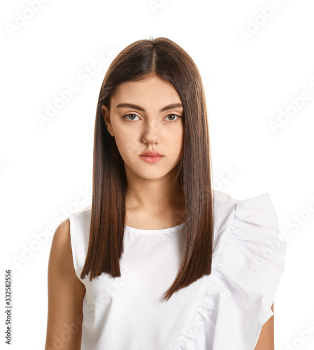 Young woman with beautiful straight hair on white background © Pixel-Shot