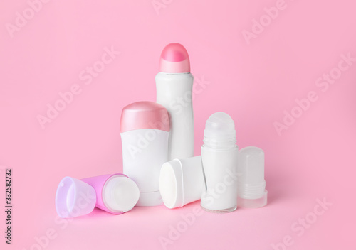 Different deodorants on color background