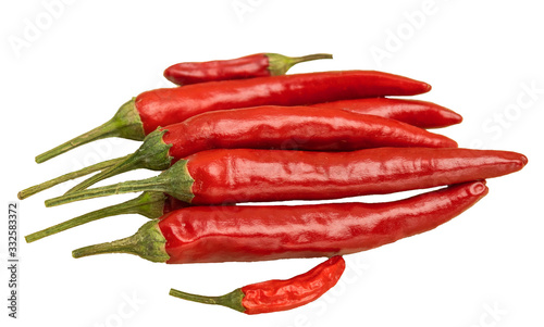 Hot peppers in a glass plate on a wooden background