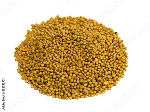 Mustard seed seasoning in glass plate on wooden background