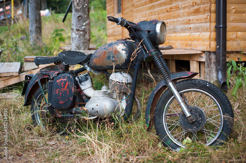An old motorcycle parked in countryside