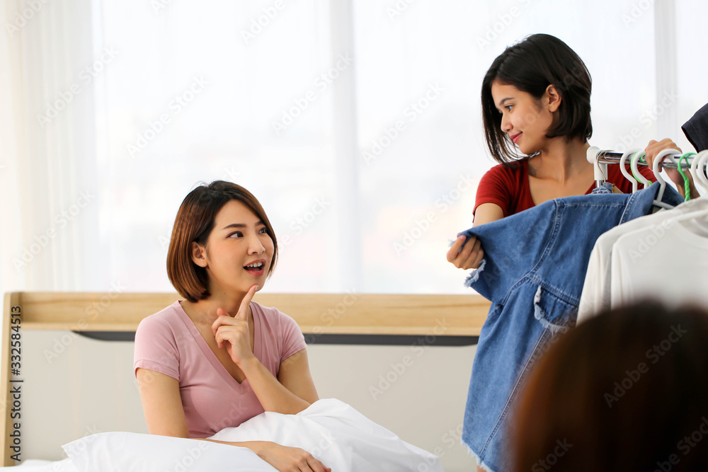 Asian lover couple women choosing clothes together in bedroom,morning time. Asian lover couple women choosing clothes together in bedroom,morning time.