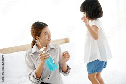 Young mother washs her baby's hand by using a hand wash sanitizer gel. In the epidemic virus situation