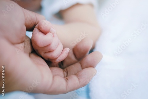 Close up and selective focus hands of mother and baby .Family and love concept.