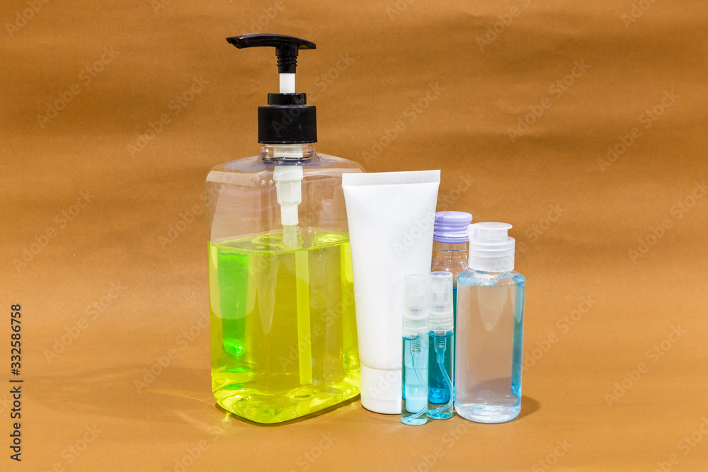 Bottle of antiseptic hand gel, alcohol and alcohol spray on brown background. Disease kill set for corona virus or covid-19 protection. Bottle of antiseptic hand gel, alcohol and alcohol spray on brown background. Disease kill set for corona virus or covid-19 protection.