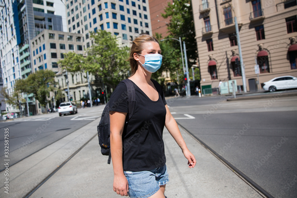 Woman in Face Mask Crossing the Road