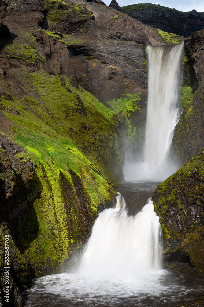Fototapeta premium Beautiful smooth waterfall in Iceland during sunny day