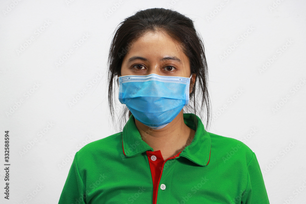 Masked Asian woman prevent germs and wear green shirt. Tiny Particle or virus corona or Covid 19 protection. Masked Asian woman prevent germs and wear green shirt. Tiny Particle or virus corona or Covid 19 protection.