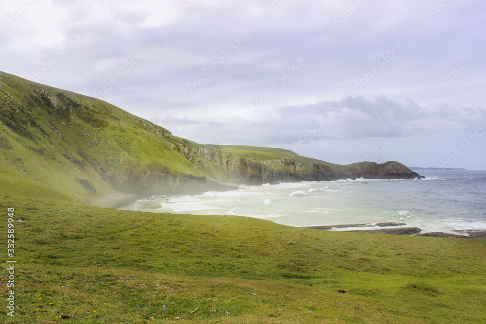 Green hills on foggy shoreline Green hills on foggy shoreline