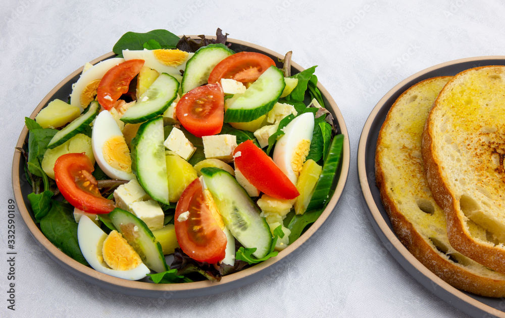 Egg, Feta, and some vegetable salad like cucumber, tomato and potato Egg, Feta, and some vegetable salad like cucumber, tomato and potato