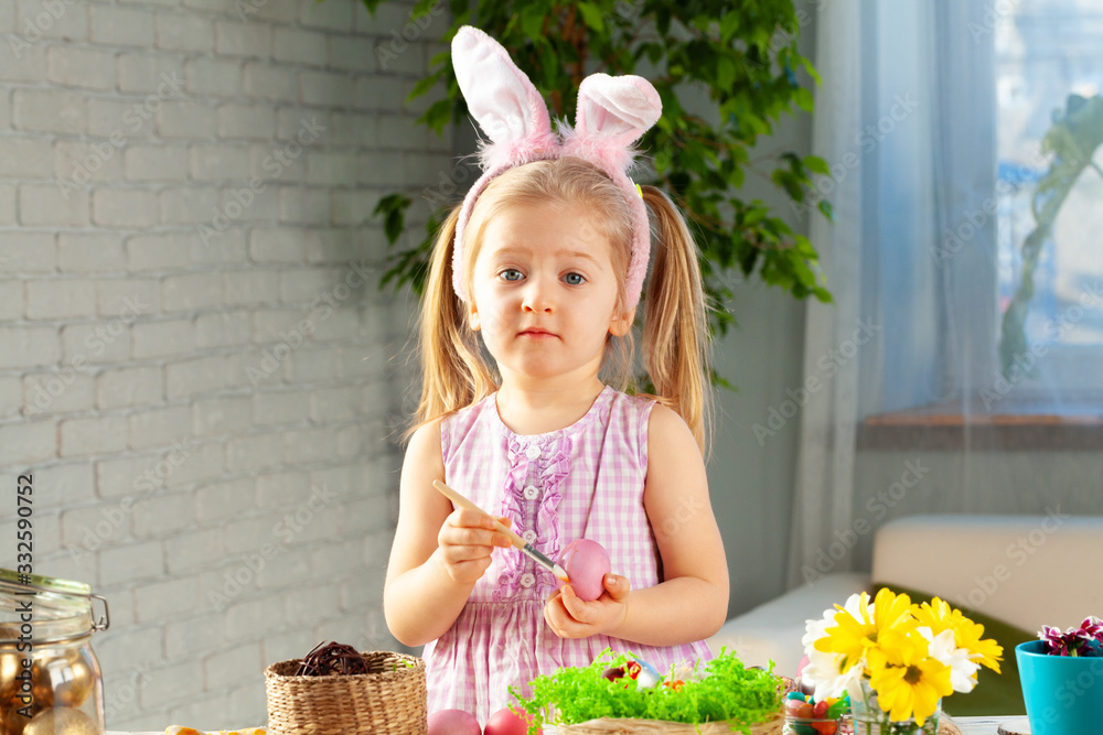 Little girl painting eggs for Easter at home Little girl painting eggs for Easter at home