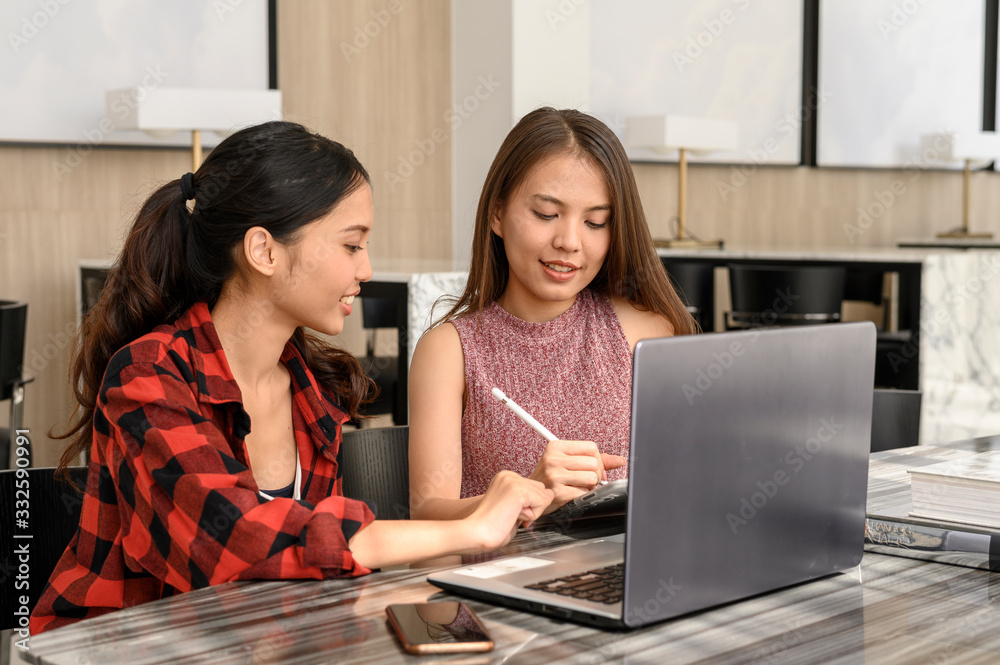 Asian Young women working in modern office or coworking space. Asian Young women working in modern office or coworking space.