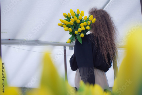 flowers in hand, girl with tulips, curly hair
