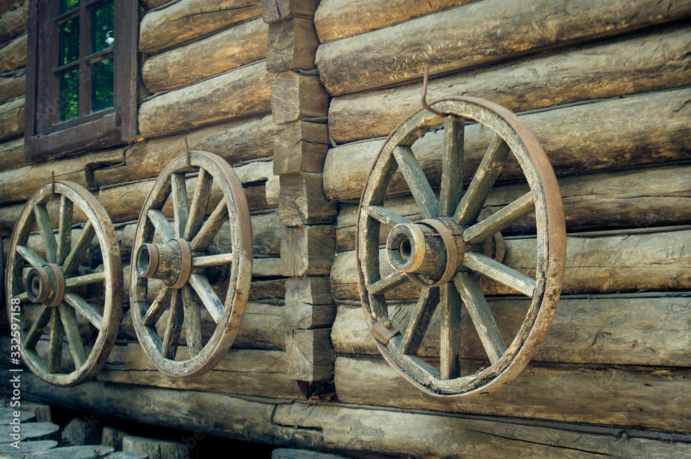 wooden wheels hang on a house