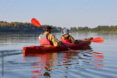 Couple kayaking on Danube river together. Having fun in leisure activity. Romantic and happy woman and man on the kayak. Sport, relations concept.