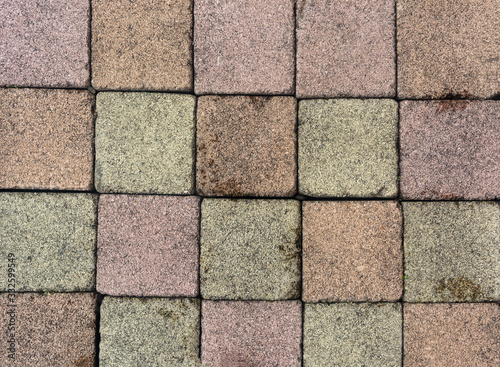 Brick pavement tile  top view. Urban texture as background. Stone pavement texture. Granite cobblestoned pavement background. closeup