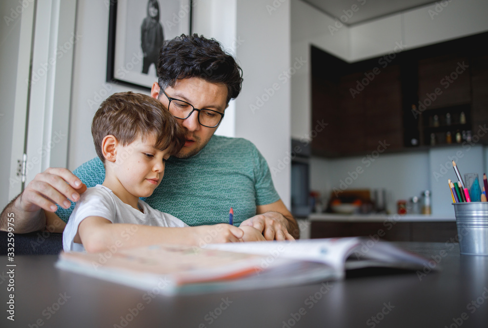 Father homeschooling his son Father homeschooling his son
