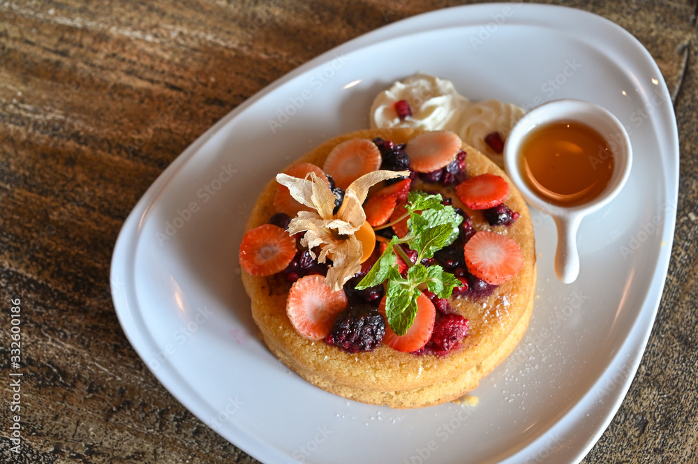 Pancake with mixed berries on wooden table Pancake with mixed berries on wooden table