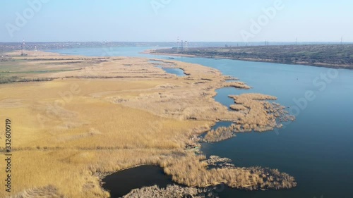 The rivercoast is overgrown with reeds. Aerial view to the Ukrainian nature and landscape. Beauty nature from above.  photo