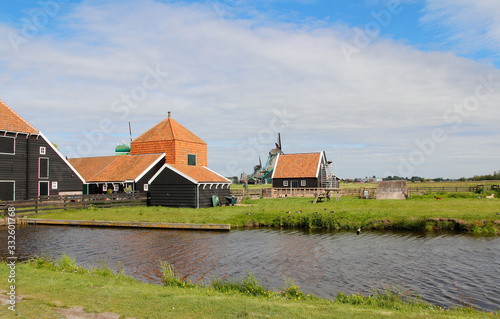 View of traditional Dutch farm houses along a canal in spring at the Zaanse Schans, Zaandam, Netherland