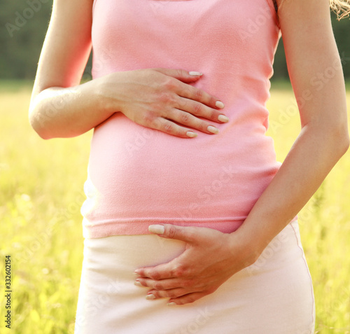 Wallpaper Mural belly of a pregnant woman in nature Torontodigital.ca