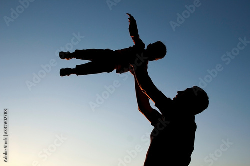 silhouette of father and son