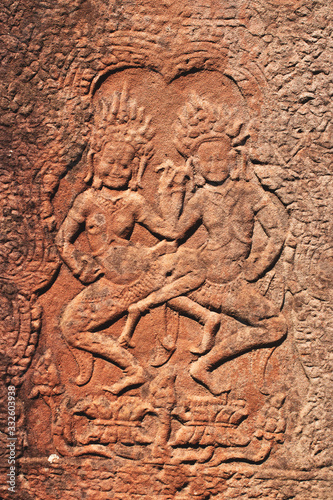 Ancient Khmer carving/relief of two goddesses. Wall of Bayon Temple, Angkor Thom, Siem Reap, Cambodia.