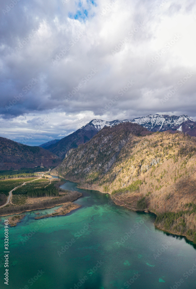 Obraz premium Aerial view of Almsee lake in the austrian alps during Spring